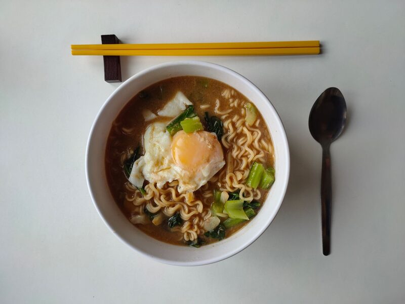 Noodles topped with a fried egg