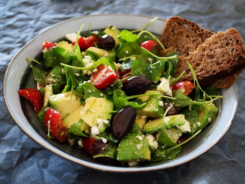 Fresh salad bowl with avocado and olives