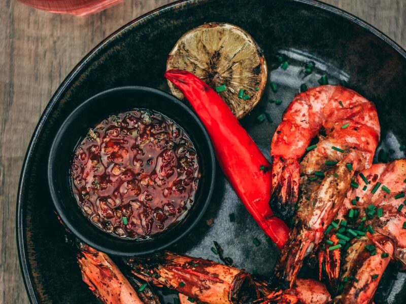 Grilled prawns on a dark plate